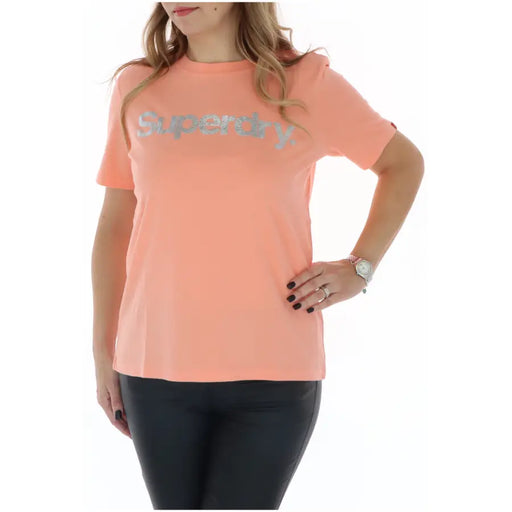 Superdry women’s peach-colored round neck t-shirt with silver glitter logo printed across the chest