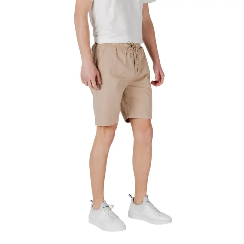 Tan drawstring shorts made of beige cotton with a drawstring waistband and subtle side pockets for casual wear
