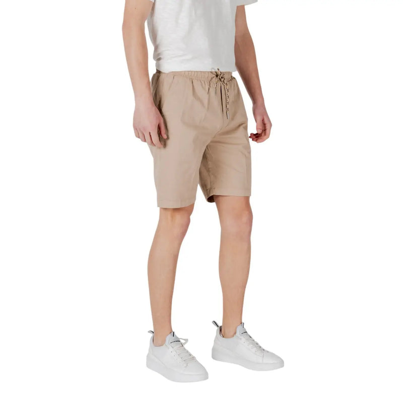 Tan drawstring shorts made of beige cotton with a drawstring waistband and subtle side pockets for casual wear