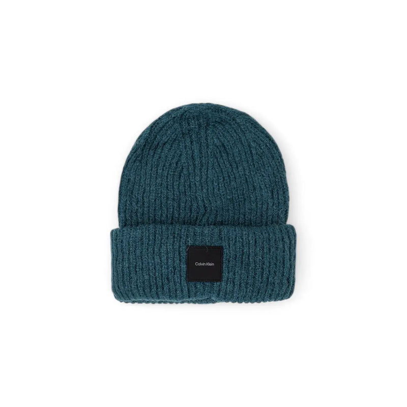 Teal ribbed knit beanie with folded cuff and black Calvin Klein logo patch made of soft knit fabric