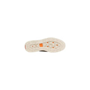 Timberland men lace up beige suede shoes with white rubber sole featuring orange diamond accents and textured tread