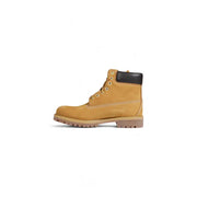 Timberland men’s brown leather slip on boots featuring tan 6-inch design with black rubber heel collar and gold eyelets
