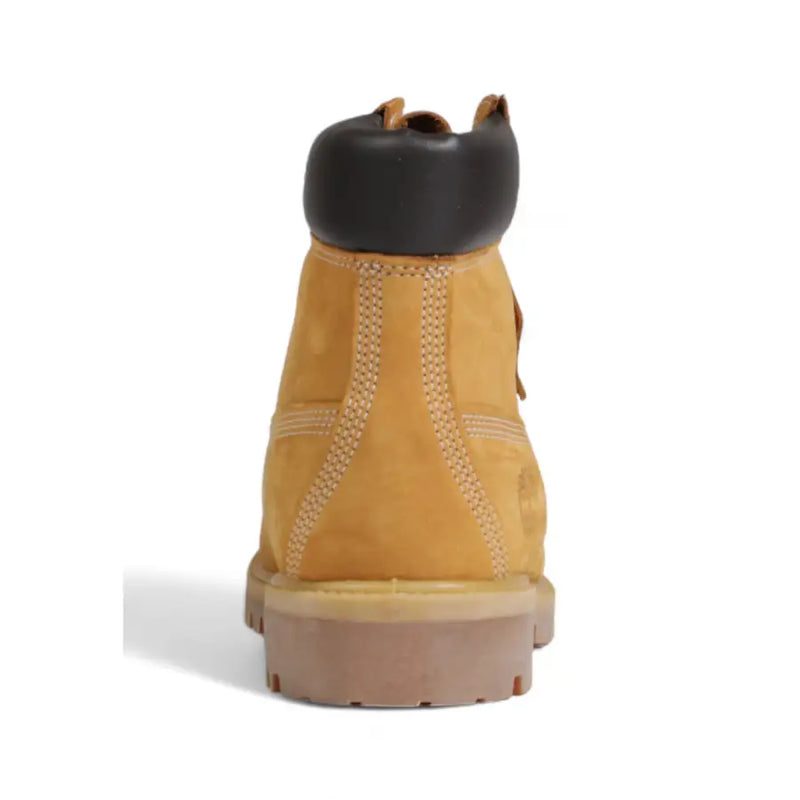 Timberland men’s brown leather slip on boots featuring tan suede 6 inch design with black rubber toe cap and tan outsole