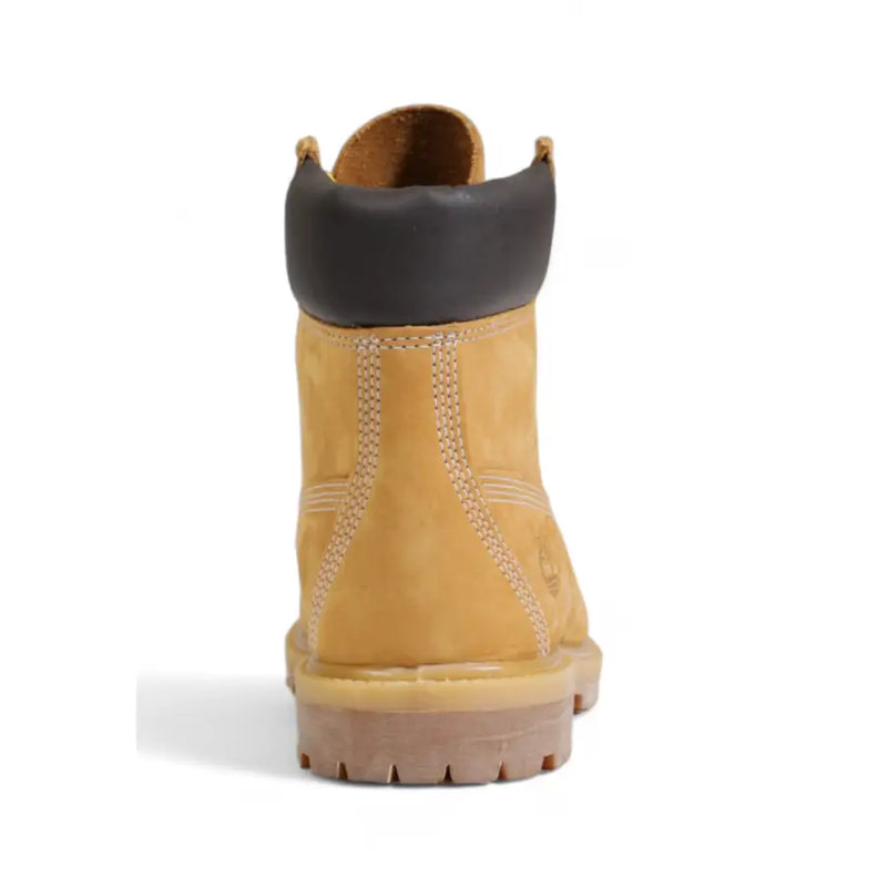 Timberland women’s beige leather ankle boots in tan suede with black rubber collar and white stitching