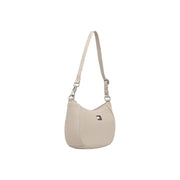 Beige tommy hilfiger women’s shoulder bag with sleek curved design zip pocket and subtle logo emblem