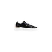Black leather sneakers with gold accents and white laces.