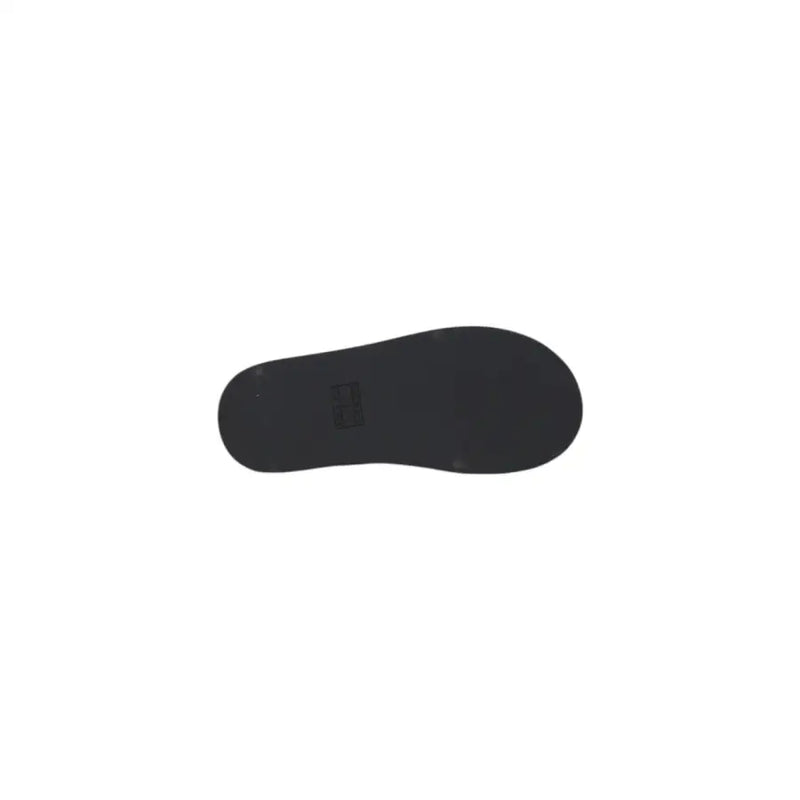 Black rubber sole with minimalist design and subtle brand logo on Tommy Hilfiger black leather wedge shoes for women