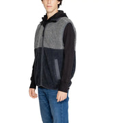 Charcoal and black sherpa vest with hood, zipper closure.