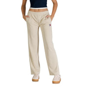 Beige tommy hilfiger sweatpants with white side stripes and small logo patch on the left thigh for women’s spring summer wear