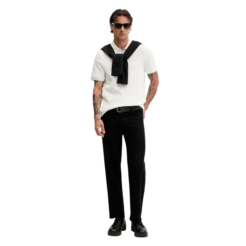 A man wearing a white short-sleeved polo shirt with a black necktie in tommy hilfiger jeans men black cotton knitwear sweater