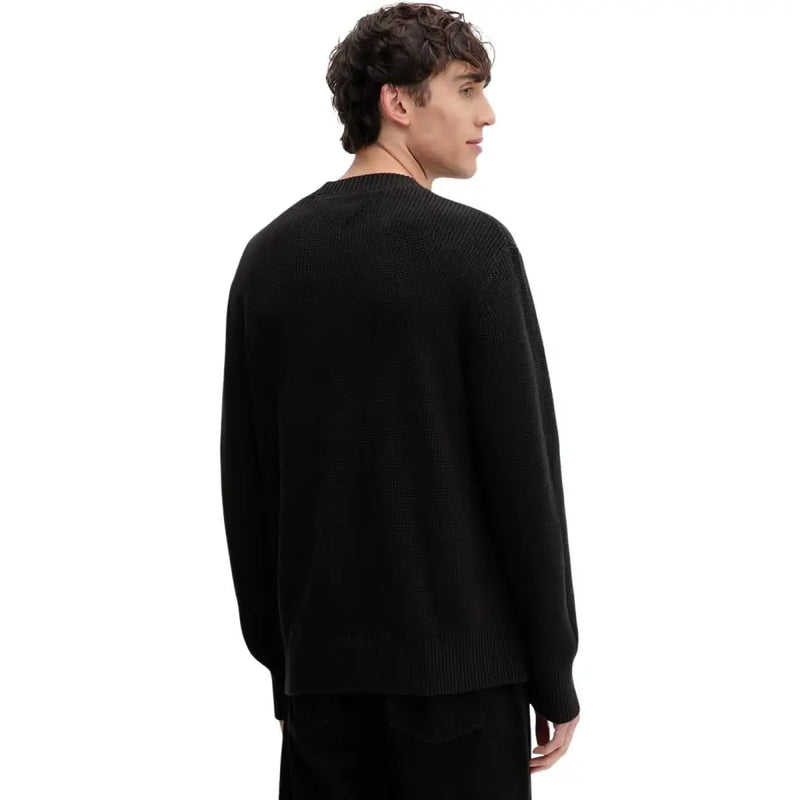 Black ribbed knit crew neck sweater with long sleeves made of organic cotton by Tommy Hilfiger Jeans men