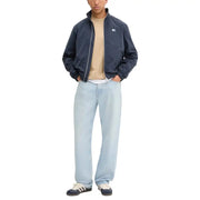 Men’s light wash baggy fit jeans from Tommy Hilfiger with blazer blue color and zip front pockets