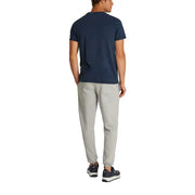 Men’s navy T-shirt and light gray sweatpants displayed with Tommy Hilfiger Jeans branding