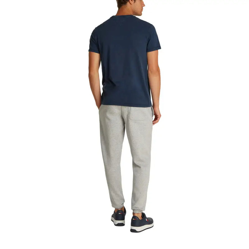 Men’s navy T-shirt and light gray sweatpants displayed with Tommy Hilfiger Jeans branding