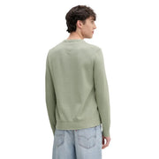 A men’s olive green organic cotton knit sweater by Tommy Hilfiger Jeans with ribbed hem and cuffs shown from the back
