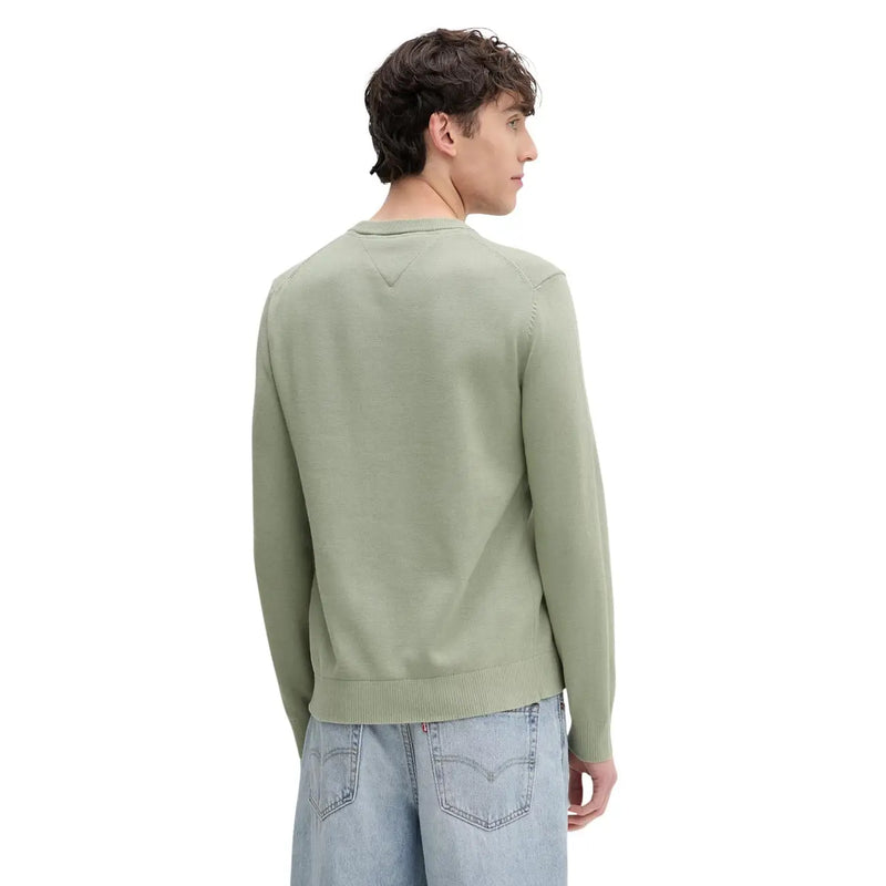 A men’s olive green organic cotton knit sweater by Tommy Hilfiger Jeans with ribbed hem and cuffs shown from the back