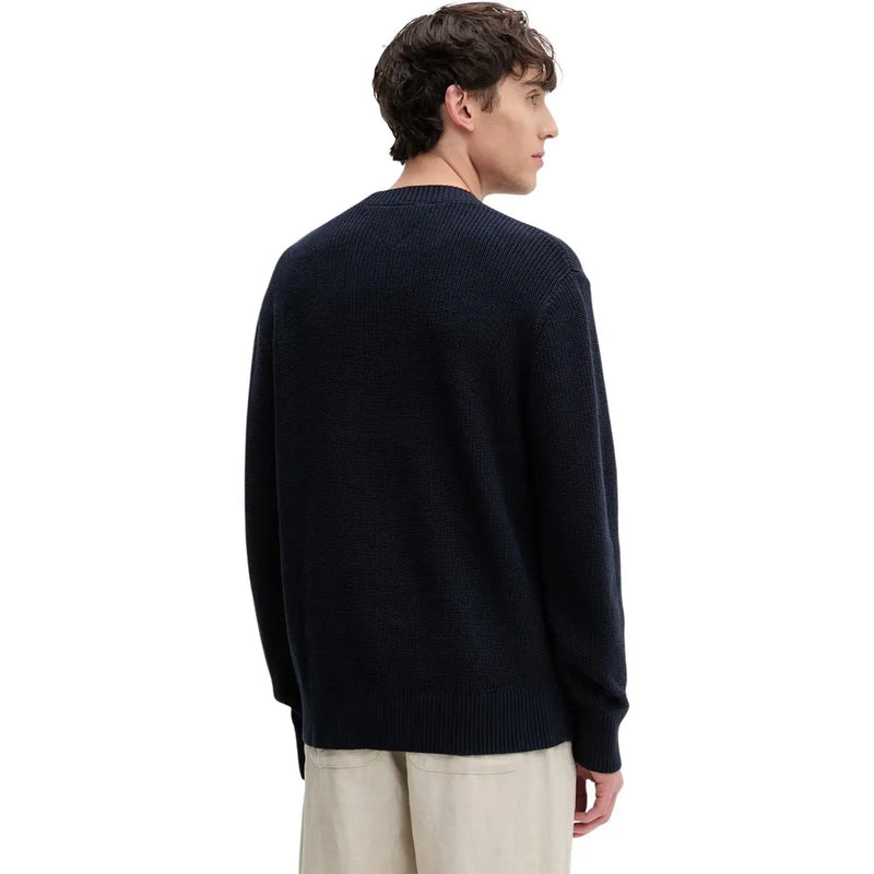 A navy blue ribbed knit sweater with crew neck and long sleeves made from organic cotton by Tommy Hilfiger Jeans