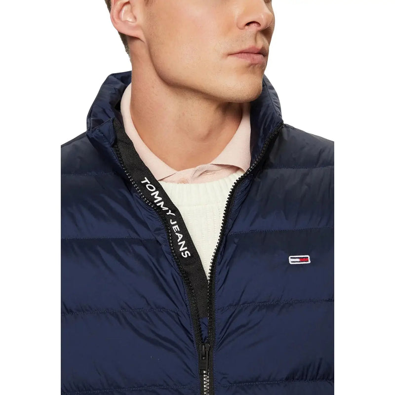 Navy blue tommy hilfiger jeans men sleeveless puffer jacket with black zipper pull and embroidered chest logo