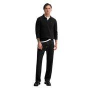 Black long-sleeved slim polo shirt with small embroidered logo made of organic cotton by Tommy Hilfiger Jeans