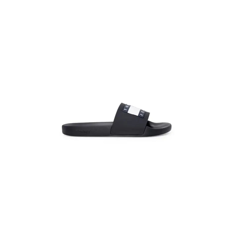 Black tommy hilfiger slide sandal with black rubber sole and white navy logo stripe across the strap size 2