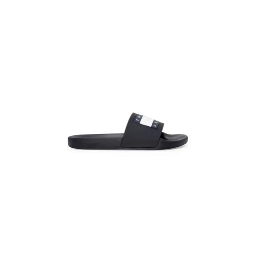 Black tommy hilfiger slide sandal with black rubber sole and white navy logo stripe across the strap size 2