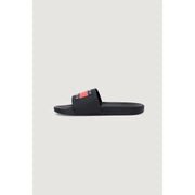 Black rubber slide sandal featuring bold red and navy Tommy Hilfiger Jeans logo stripe on foot strap size 2
