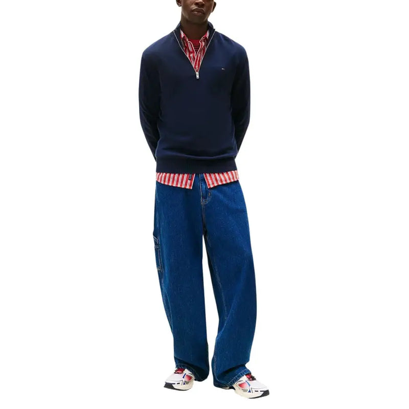 Navy blue half-zip Tommy Hilfiger Jeans men’s sweatshirt with logo worn over a red and white striped shirt