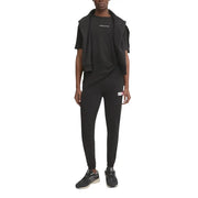 Black tommy hilfiger jeans jogger pants with small white and red logo patch on the left thigh for men