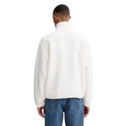Men’s cream-colored fleece half-zip jacket and blue jeans paired with Tommy Hilfiger Jeans blazer