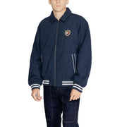 Dark blue bomber jacket with collar, white stripes, and embroidered emblem on chest