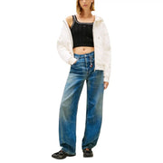 Wide-leg blue denim jeans with faded distressed look and visible stitching paired with tommy hilfiger organic cotton top