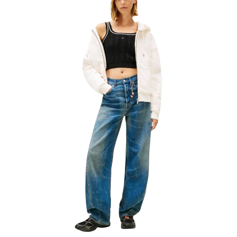 Wide-leg blue denim jeans with faded distressed look and visible stitching paired with tommy hilfiger organic cotton top