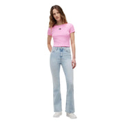 A woman wearing a pink ribbed cotton tommy hilfiger crop t shirt paired with light-wash flared jeans