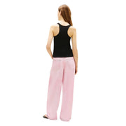 Pink wide-leg cotton trousers with relaxed fit and front pockets paired with tommy hilfiger black tank top