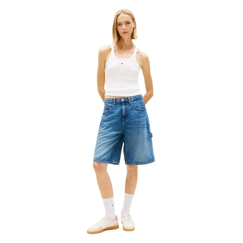 Blue denim shorts with five-pocket design and subtle fading paired with tommy hilfiger white cotton tank top straps