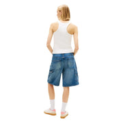 Blue denim shorts with cargo pockets and relaxed fit paired with tommy hilfiger white cotton tank top straps