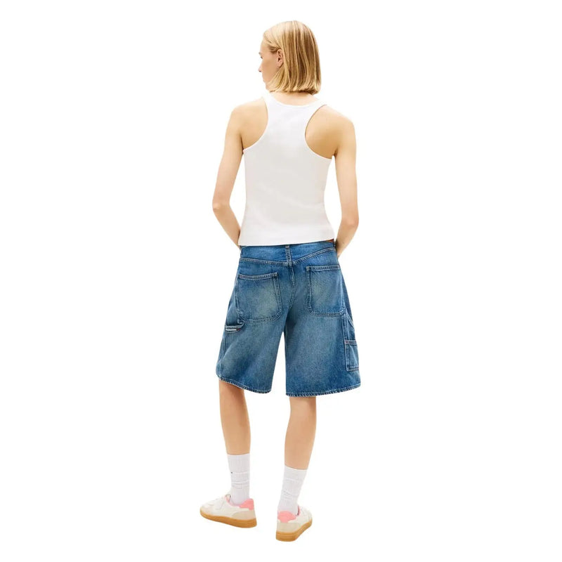 Blue denim shorts with cargo pockets and relaxed fit paired with tommy hilfiger white cotton tank top straps