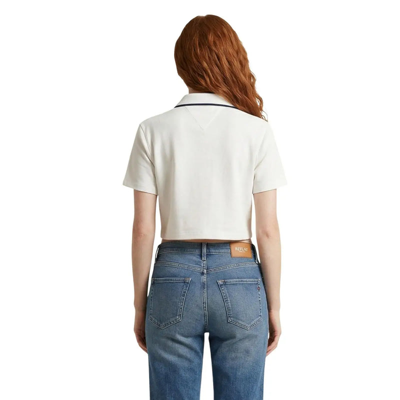 Cream-colored short-sleeved polo shirt with navy trim and branded leather patch at waistband by Tommy Hilfiger Jeans