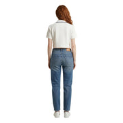 A pair of medium-wash blue denim tommy hilfiger jeans with a straight-leg cut and brown leather patch at the waistband