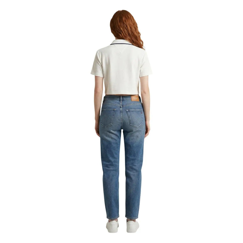 A pair of medium-wash blue denim tommy hilfiger jeans with a straight-leg cut and brown leather patch at the waistband
