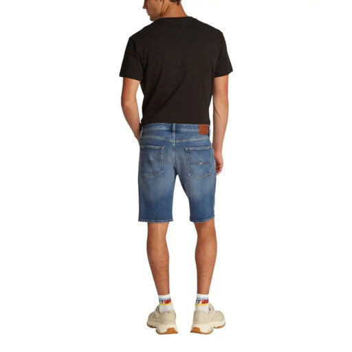 Blue denim mens shorts with classic five-pocket design and brown leather brand patch on back waistband by tommy hilfiger