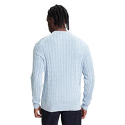 Light blue cable knit sweater with navy pants and dreadlocks.
