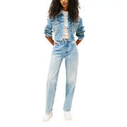 Woman wearing Tommy Hilfiger light blue denim jeans with worn out effect and white sneakers