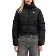 Black cropped puffer jacket with hood over dark gray jeans displayed in Tommy Hilfiger product image