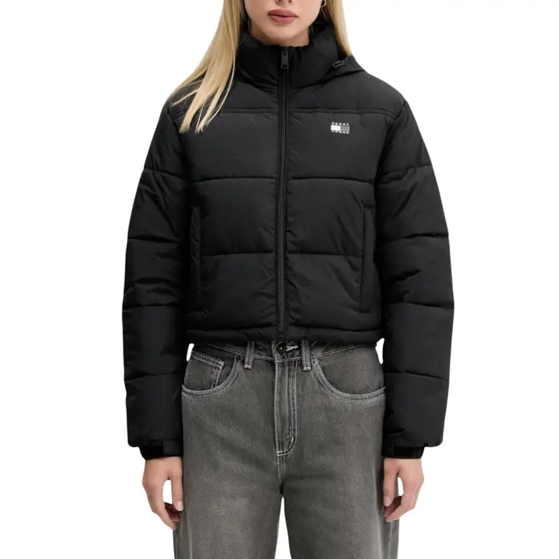 Black cropped puffer jacket with hood over dark gray jeans displayed in Tommy Hilfiger product image