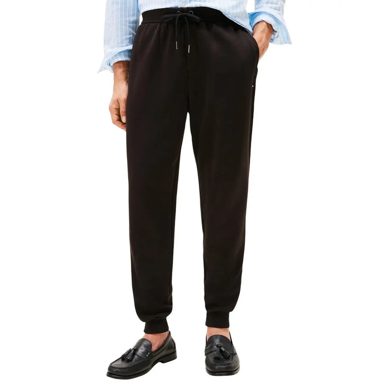 Black cotton drawstring joggers with a relaxed fit and ribbed cuffs from Tommy Hilfiger men trousers collection