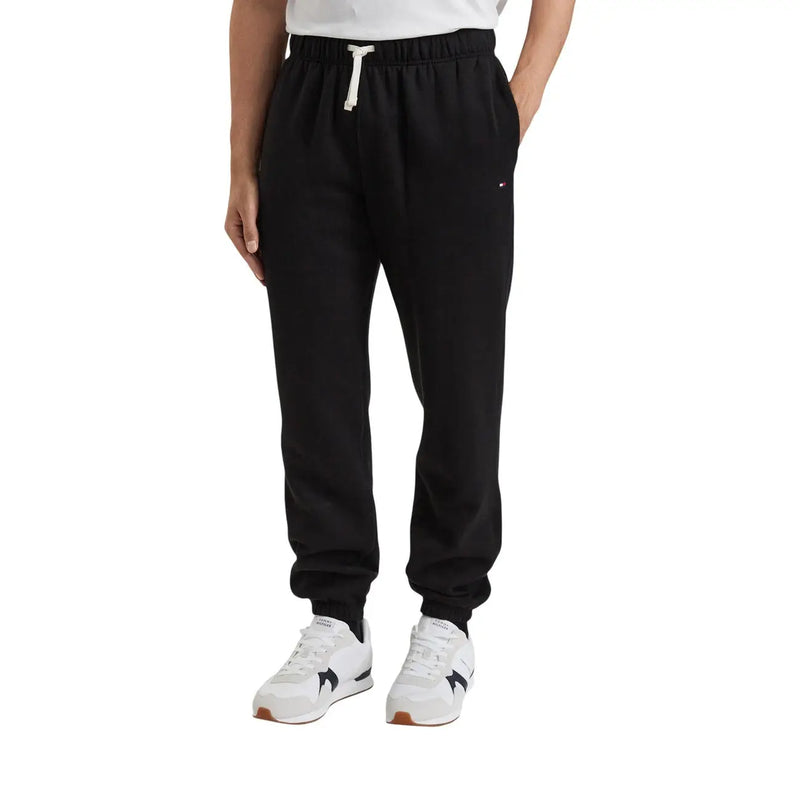 Black tommy hilfiger men fleece trousers cotton blend with white drawstring and subtle logo on thigh front view