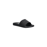Black tommy hilfiger slide sandal in polyurethane with a minimalist design and subtle logo on the strap size 41
