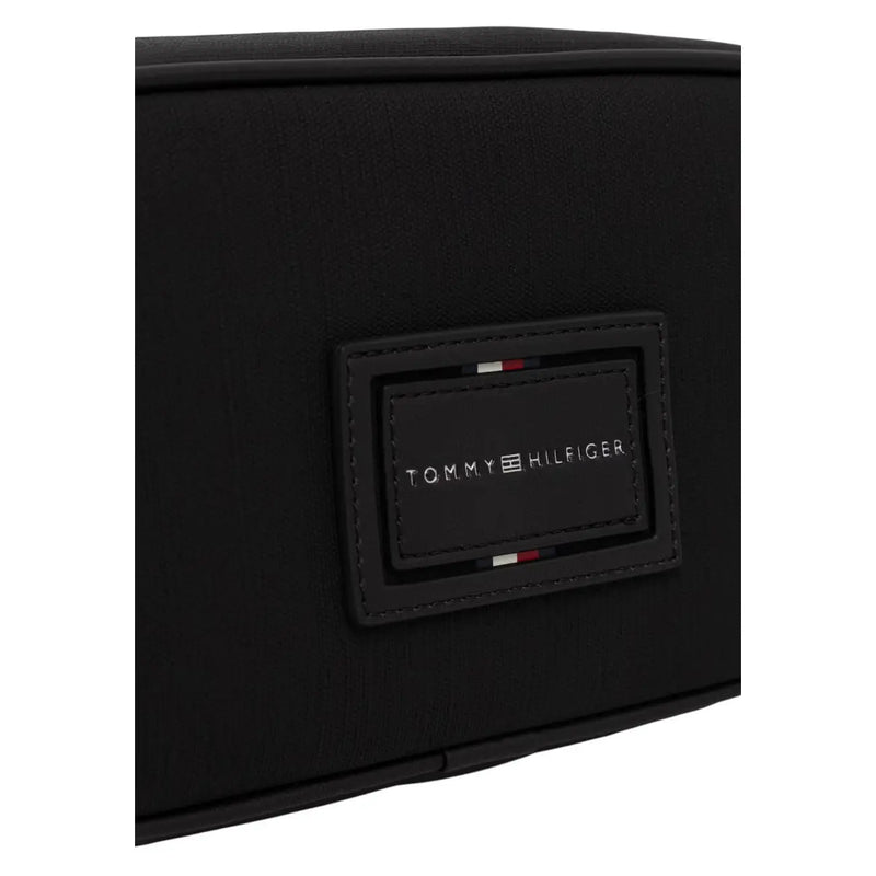 Black tommy hilfiger rectangular polyurethane patch with stitched edges and red white blue stripe on men washbag