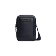 Black textured leather crossbody bag with Tommy Hilfiger logo plaque and flag emblem, 20cm mini reporter style